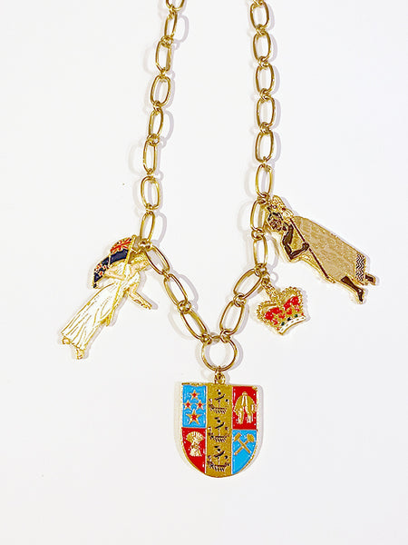 A unique deconstructed take on our very own Coat of Arms.  This necklace is truly a statement piece and comes with iconic components.   Zinc alloy, electroplated gold, and handpainted enamel charms. Made in Aotearoa Chain Length: 48cm oval belcher stainless gold chain. A standout, center of attention design patriotic to Aotearoa
