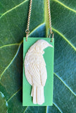 Swinging long tūī bird statement pendant. Long length chain to wear over your winter sweater.  2020 Winter new handcrafted 3-dimensional Tui on swinging long chain.  Confident spiritual warrior, the Tui brings harmony and holds power as a messenger to the gods.   Pantone resin colour option: Cream base with Black Tui- Black Stainless Chain, Navy Base with Cream Tui- Gold Stainless Chain and Lime Apple Green base with Cream Tui-Gold Stainless Chain. 