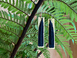 Poutama Porourangi tukutuku design on the huia feather represents the search for knowledge and was a pattern introduced by Tania's ancestor Sir Apirana Ngata representing their famous ancestor Porourangi of Ngati Porou.   Shaped like the tukutuku panels that adorn the walls of our wharenui 50 mm (H) x 10 mm (W) x 3 mm (D) Handcrafted 3-dimensional resin art on sterling silver hooks.
