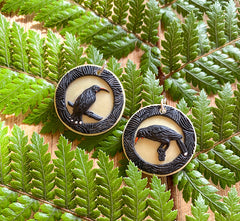 Tania Tupu's portrait earrings of the extinct Huia bird sadly silenced before our generation could hear their song.   Portrait framed Huia female and male paired together on sterling silver hooks. Wearable handcrafted 3-dimensional Huia artworks. 