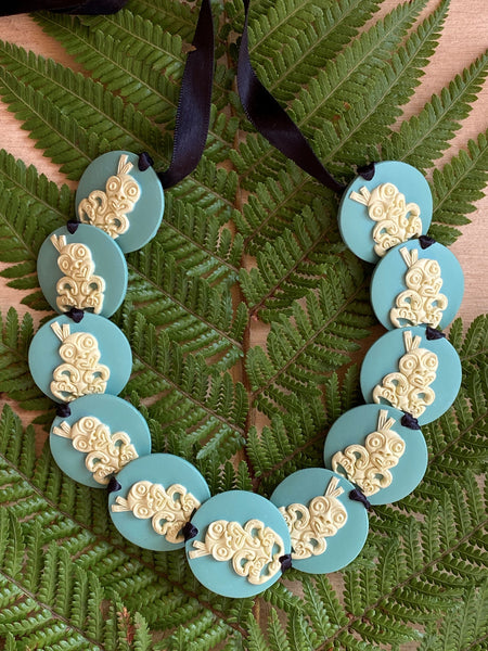 Wearable handcrafted 3-dimensional 30mm Tiki beads woven together with double-sided silk ribbon and finished with an adjustable toggle.